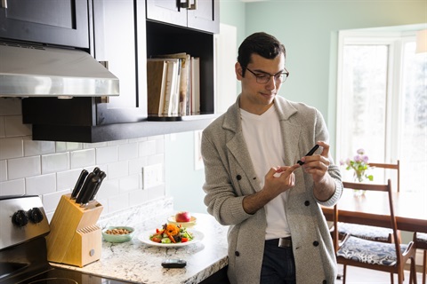 Young man checks his blood sugar