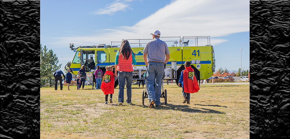 Family walking toward fire truck