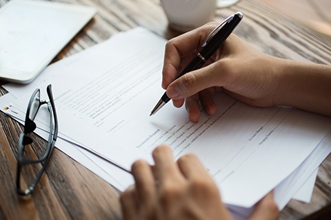 A person signs a legal document.